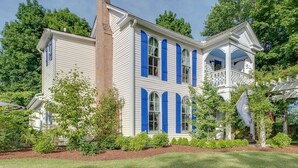 A white building with blue shutters and a porch. - Private, 2 Bedroom Suite with Balcony at Farmhouse Retreat, Central Location (Nashville)