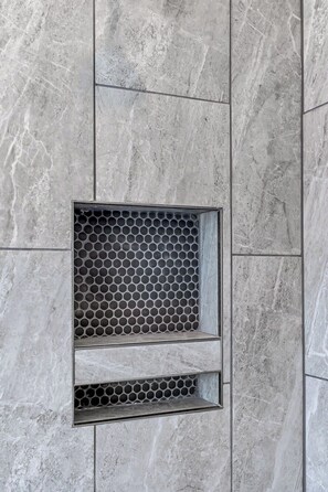 A wall with a rectangular window featuring a honeycomb pattern.