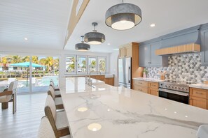 Fridge, microwave, oven, stovetop - Pink Pearl – Private Canal home in Key Royale, Heated Pool/Hot Tub and Dock avai (Holmes Beach)