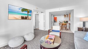 A modern living room with a beach view, a dining area, and a kitchen. - Eternal Sunrise (Fort Lauderdale)