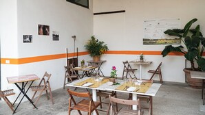 A dining area with tables and chairs, a menu board, and potted plants. - B&B Tenuta di Paganico - Wine & Food (Civitella Paganico)