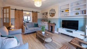A spacious living room with a sofa, coffee table, and TV. - 3br-garden-freeparking-neartowncentre (Ipswich)