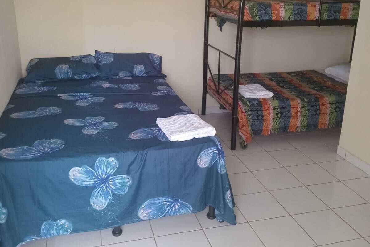 A room with a single bed and a bunk bed.