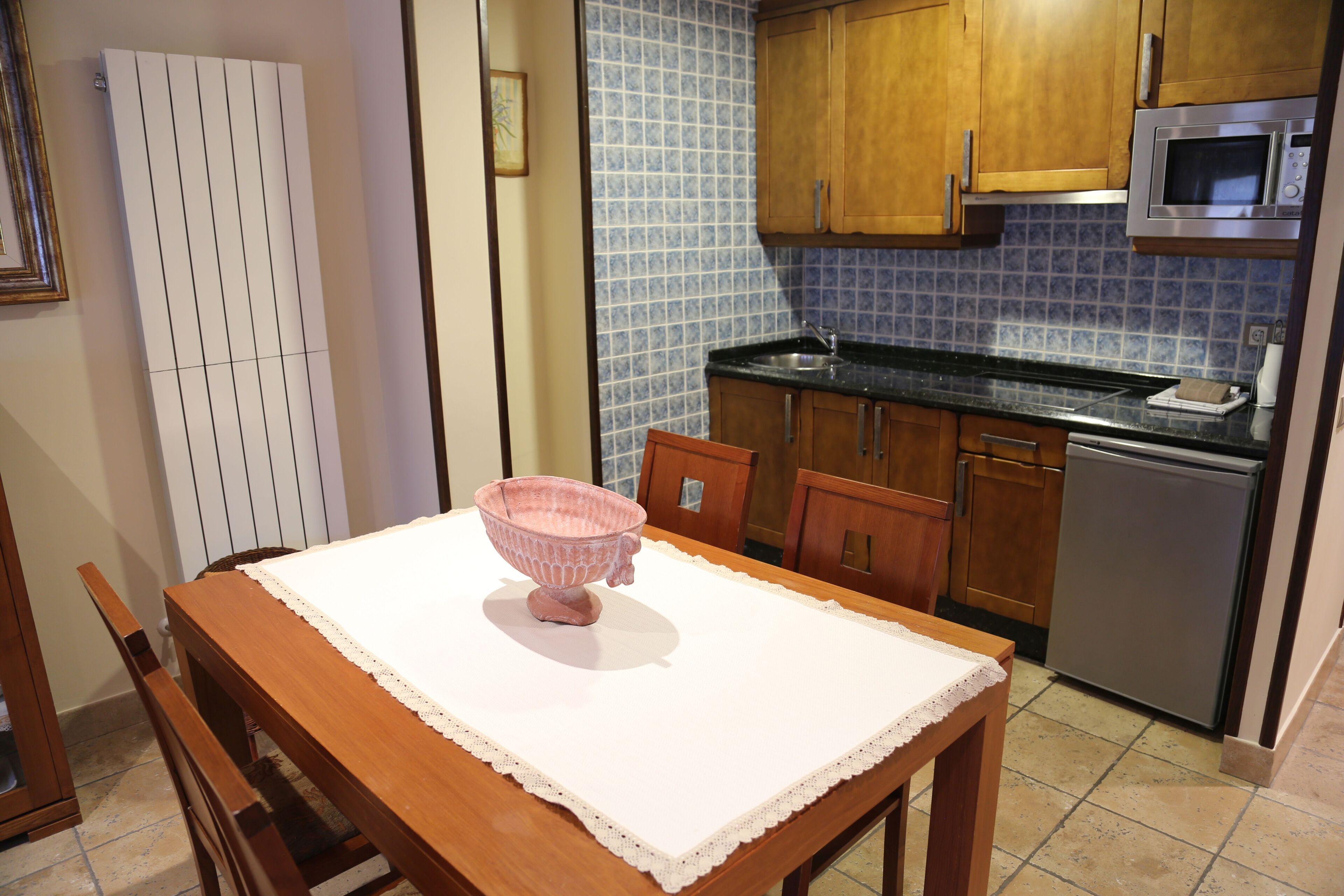 Una cocina con armarios de madera, un microondas y un lavabo.