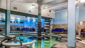 A spa area with multiple hot tubs and seating areas. - Superb 2BR Condo w/ Charming Mountain View & Pool (Canmore)