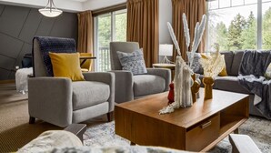 A modern living room with grey sofas, a wooden coffee table, and decorative vases.