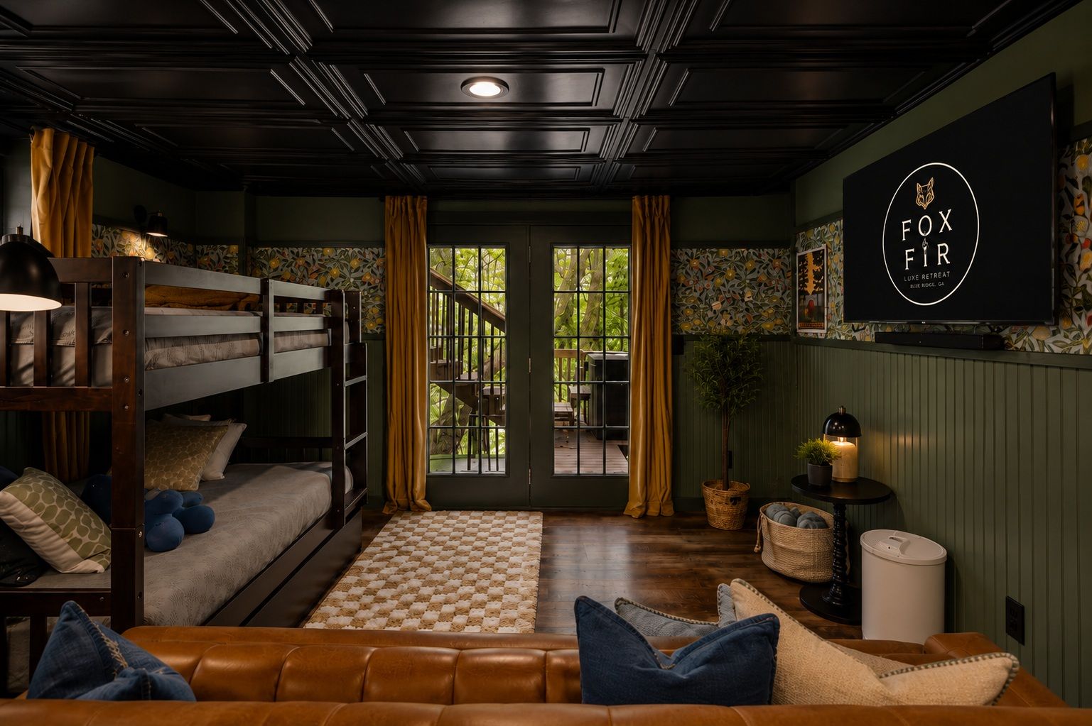 A cozy room with a bunk bed, a leather sofa, a television, and a window with curtains.