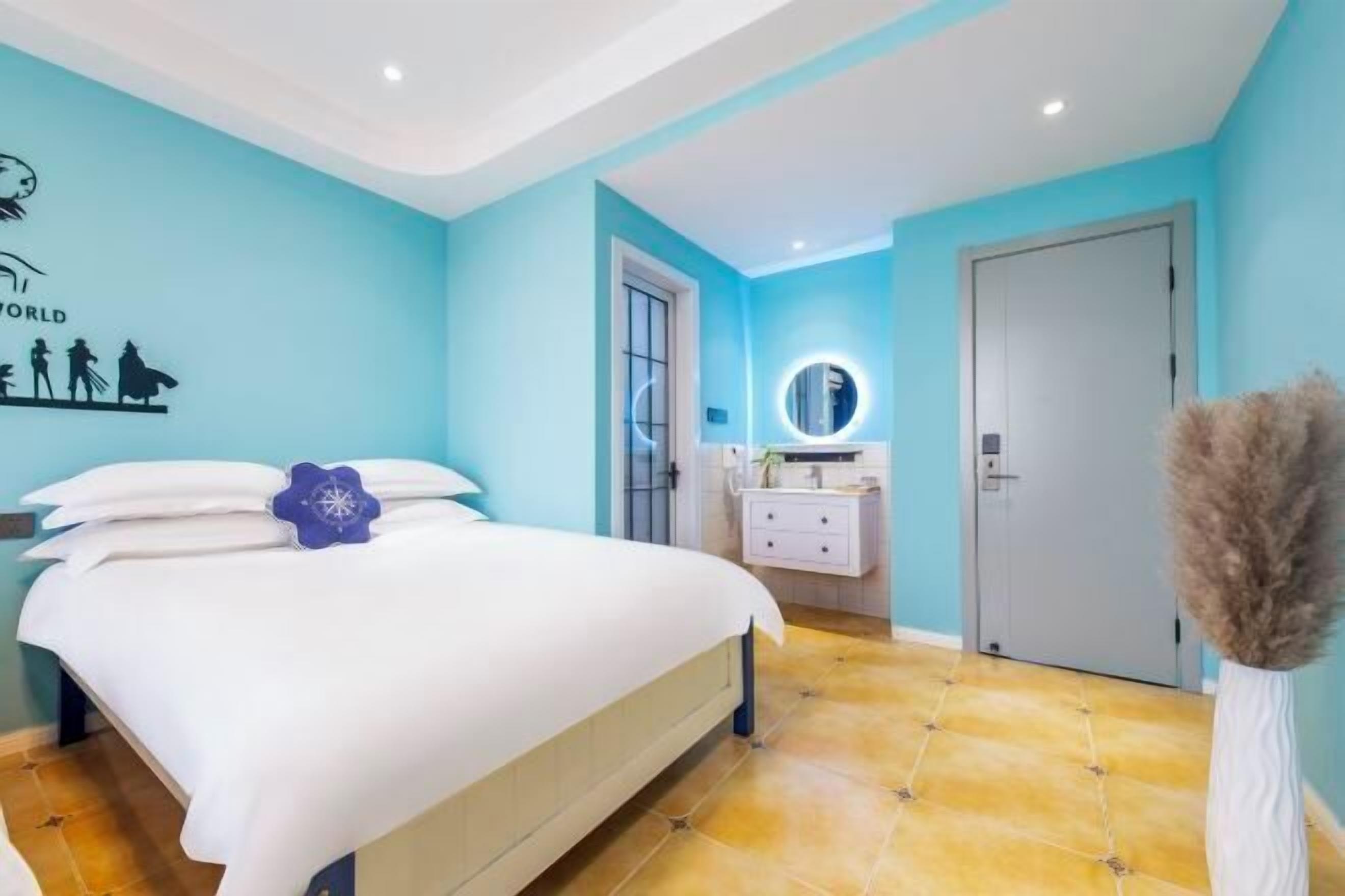 A bedroom with a bed, a bedside table, a mirror, a door, and a wall with a silhouette of people and the word 'WORLD'.