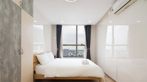 Une chambre à coucher moderne avec une grande fenêtre, un lit et une armoire.