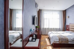 A hotel room with two beds, a TV, a desk with a coffee maker, and a window with curtains. - YunLong HOTEL (Ongniud Banner)