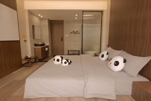 A bedroom with a bed, a bedside table, a mirror, and a wardrobe. - Yinan Inn (Dujiangyan)