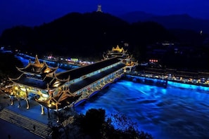 A traditional building with multiple levels and a long, narrow structure. - Yinan Inn (Dujiangyan)