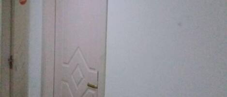 A door with a number plate and a geometric design.
