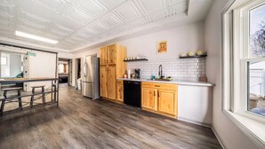 A modern kitchen with wooden cabinets, a stainless steel refrigerator, and a dishwasher. - 5BedR, Sleeps 16, Big Yard, Game Room, Pet OK, CVNP (Cuyahoga Falls)