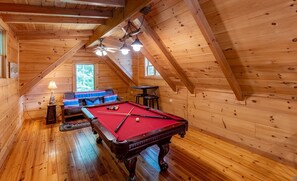 A wooden interior with a pool table, a sofa, and a table with chairs. - Hawk's Landing-Private Luxury Log Cabin Rental, Mountain Views, High Speed Internet, Hot Tub - 15 minutes from the NOC! (Topton)