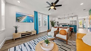 A modern living room with a TV, sofa, and dining area.