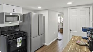 A kitchen with a built-in microwave, refrigerator, and stove.