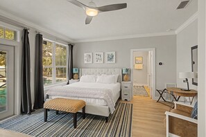 A bedroom with a bed, a bench, a desk, and a ceiling fan. - Barefoot Bliss | 5BR | Screened-in Pool & Spa! Carriage House! Walk to Beach! (Santa Rosa Beach)
