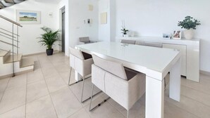 A modern kitchen with a central island, a staircase, and a potted plant. - Beautiful home in Cullera (Cullera)
