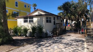 A small, single-story house with a porch and a number '106' on the front. - Cozy Cottage, 1 bedroom sleeps 2 (Bradenton Beach)