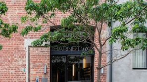 Welcome to Barnetwich, a charming building with a brick facade and a large entrance door.