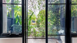 Enjoy a serene view of the lush garden from the balcony, perfect for relaxation or outdoor dining.
