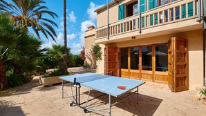A ping pong table in an outdoor area with a building in the background. - Country House 'Magdalena - Son Gaya' with Private Pool, Wi-Fi and Air Conditioning (Illes Balears)