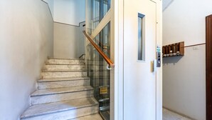 Una escalera de mármol que conduce a una puerta de cristal.