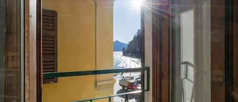A balcony with a view of a snowy landscape and mountains.