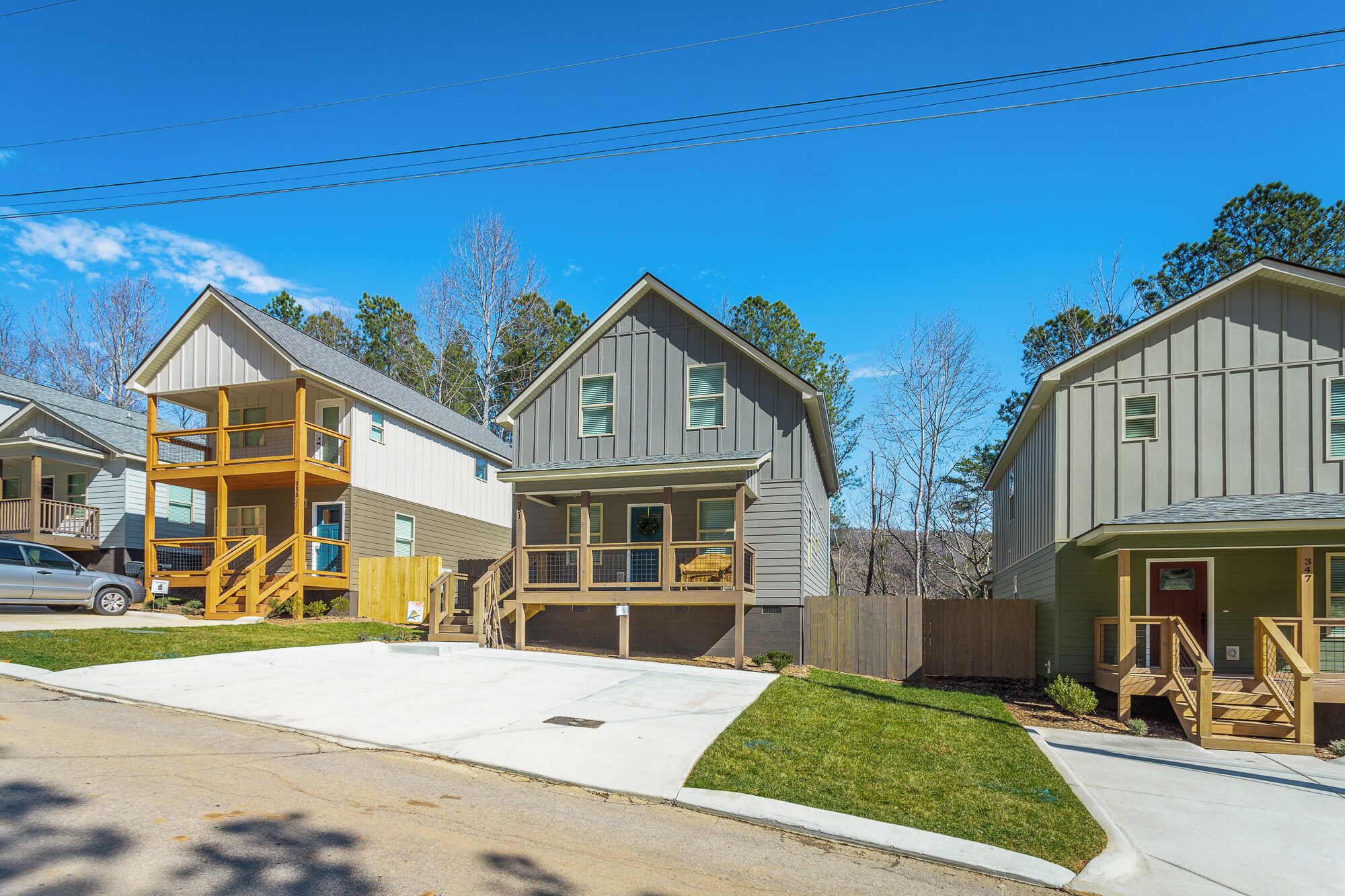 A row of two-story houses with attached porches and a garage.