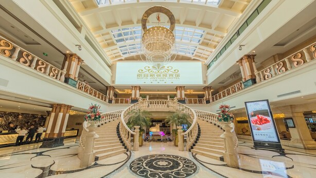 A grand hotel lobby with a central staircase, a chandelier, and a reception desk. - Sofis Jinyuan Hotel (Chengdu)