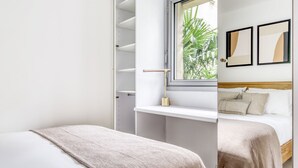 A bedroom with a bed, a window, a shelf, and a door to a closet. - Blueground | Trocadero, intercom, nr Passy Plaza (Paris)