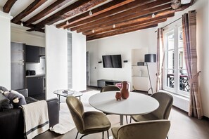 Relax in this spacious living area with a sofa, armchairs, and dining table.