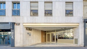 A building with a modern facade, large glass entrance, and a sign indicating the address. - Blueground | Argentine, elevator, nr Porte Maillot (Paris)