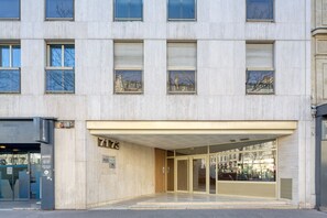 Stylish building with a flat facade and glass door entrance.