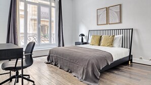 Une chambre à coucher avec un lit, un bureau et une chaise.