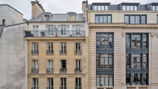 A row of multi-story buildings with balconies, large windows, and a mix of architectural styles. - Blueground | Sentier, balcony, nr Les Halles (Paris)
