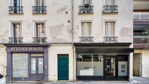 A building with two storefronts, one labeled "ATTITUDE BEAUTÉ" and the other "BODYHIT".