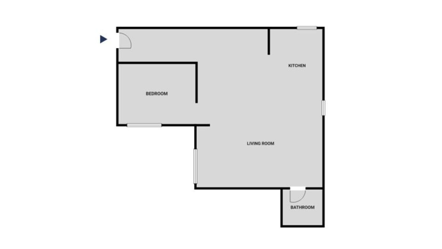 Ein Grundriss mit Schlafzimmer, Wohnzimmer, Küche und Badezimmer.