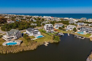A residential area with houses, a large swimming pool, and a marina.