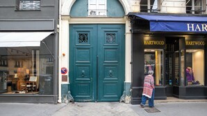 A storefront with a dark blue door and a sign reading "HARTWOOD".