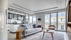 A modern apartment with a kitchen, living area, and large windows. - Blueground | Mairie du XVI, balcony, nr dining (Paris)