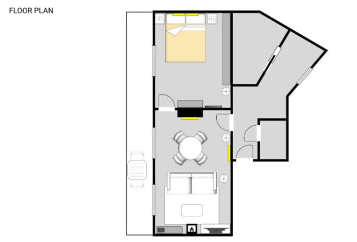A floor plan with a bedroom, bathroom, and a small dining area.