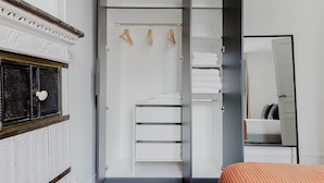 A bedroom with a wardrobe, a mirror, and a bed. - Blueground | Jardin du Luxembourg, walk to gardens (Paris)
