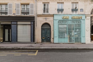 Stylish storefront with a classic arched doorway and ornate metal gate.