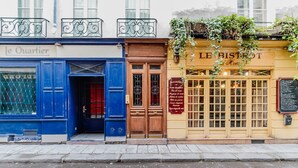 A street view of a building with a blue facade labeled "Le Quartier" and a yellow facade labeled "Le Bistro". - Blueground | Odéon, washer, nr Luxembourg Gdns (Paris)