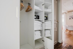Spacious walk-in closet with ample storage and a convenient radio.