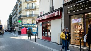 A street view with a pharmacy, a boutique, and a store with a sign reading "COTON". - Blueground | Le Marais, near Seine River (Paris)
