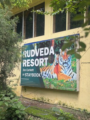 A billboard advertising Rudveda Resort by Staybook, featuring a tiger. - Staybook The Rudveda Resort (Ramnagar)