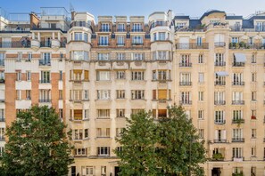 A multi-story residential building with balconies, large windows, and a uniform architectural style. - Blueground | Porte de Champerret, concierge (Paris)
